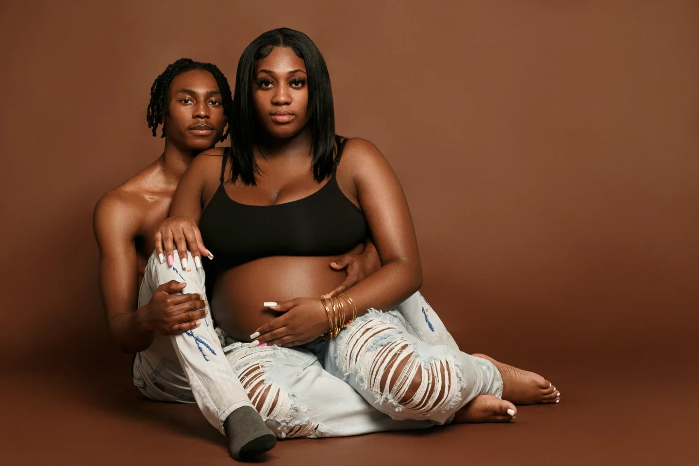 Mother and children photographed together against a warm brown studio backdrop