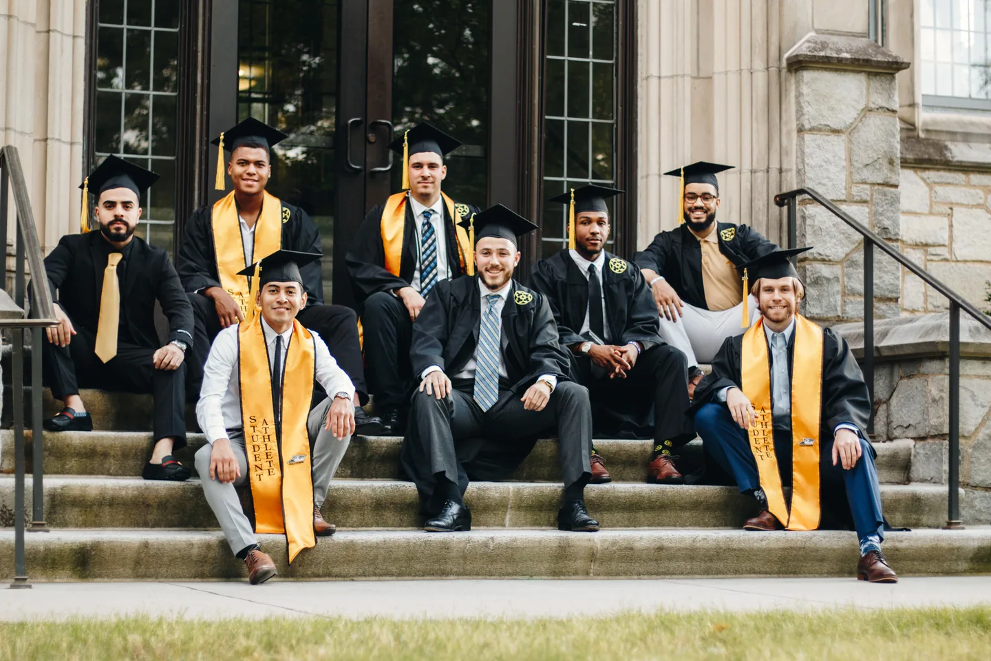 Group of graduates celebrating together on stone steps