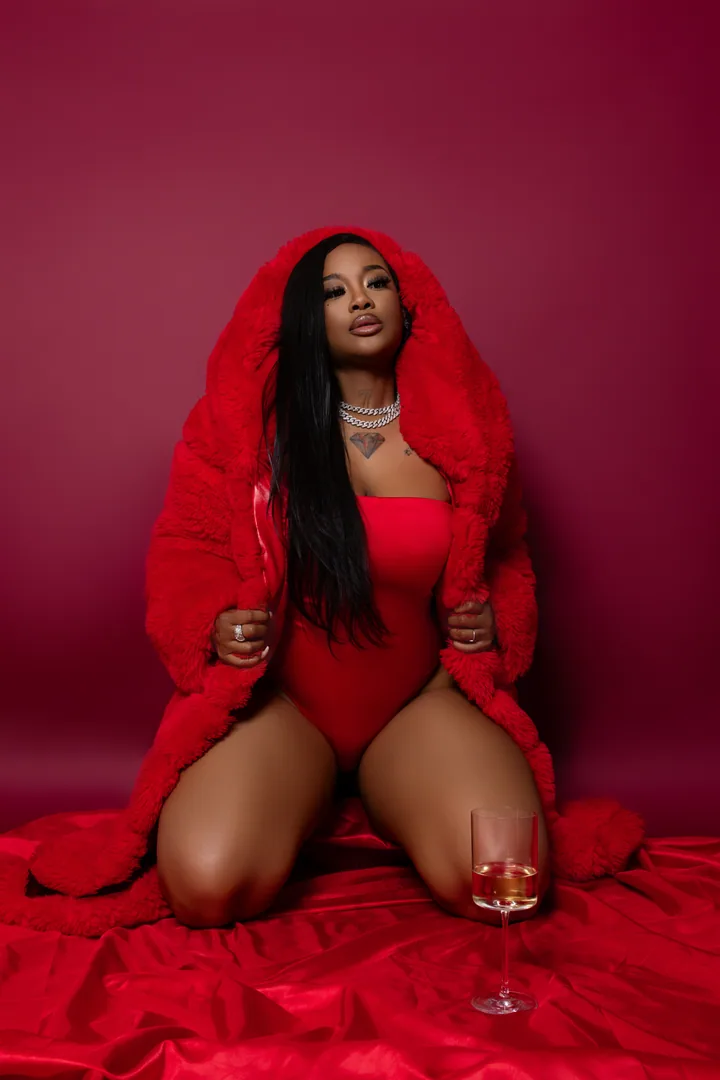 Expressive portrait in red against a deep crimson studio set